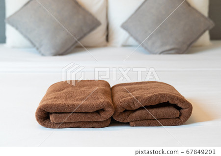 Brown towel on bed. Brown towel on bed. 67849201
