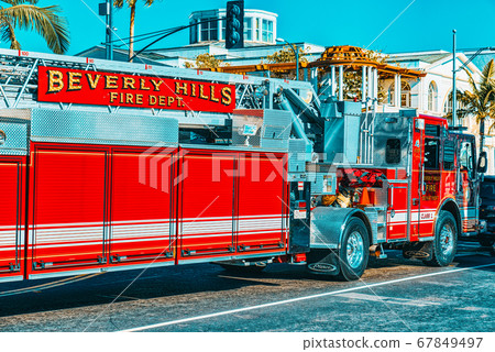 Beverly Hills area and fire trucks, hurry to fire. 67849497