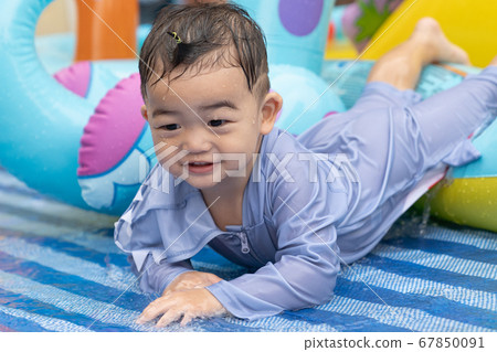 Asian cute baby boy playing in inflatable baby 67850091