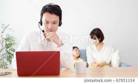 Father teleworking in the living room 67851154
