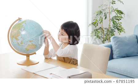 Child studying by looking at the globe Child studying by looking at the globe 67851195