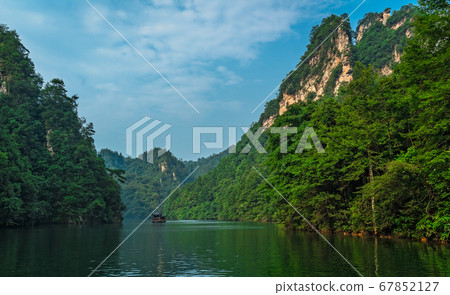 Tourist boat sailing among karst landscape on 67852127