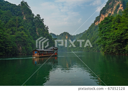 Tourist boat sailing among karst landscape on 67852128