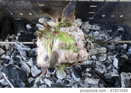 pork roast cooking on charcoal  on barbecue 67853560