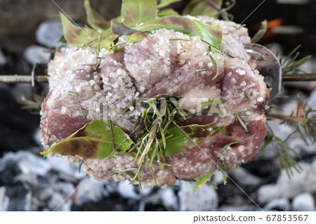 pork roast cooking on charcoal  on barbecue 67853567