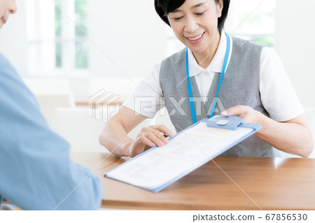 A man consulting with a parent's care facility 67856530
