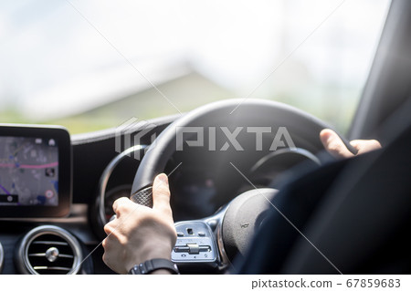 A young man driving a private car 67859683