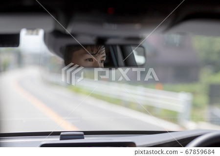 A young man driving a private car 67859684