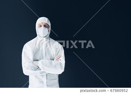 Confident doctor with crossed arms in protective medical suit with copy space Confident doctor with crossed arms in protective medical suit with copy space 67860952