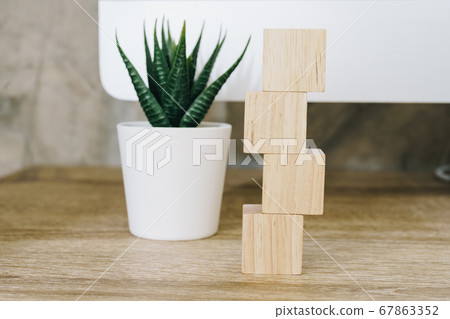 Four wooden toy cubes on wooden table background Four wooden toy cubes on wooden table background 67863352