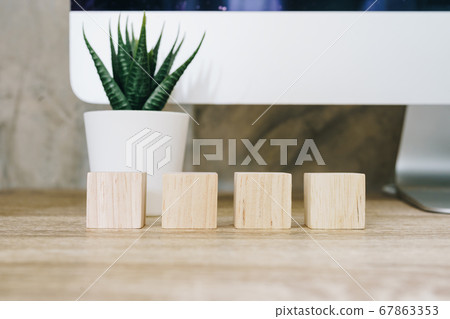 Four wooden toy cubes on wooden table background Four wooden toy cubes on wooden table background 67863353