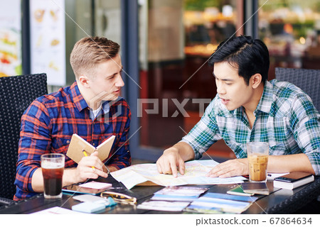 Friends planning summer vacation Friends planning summer vacation 67864634
