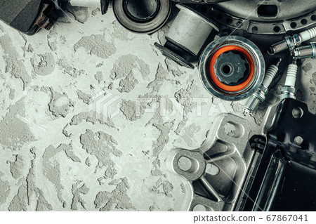 Car parts on grey textured concrete background Car parts on grey textured concrete background 67867041