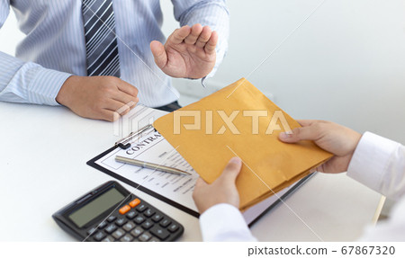 Businessmen make dollar payments while signing an investment agreement to be a partner in an illegal and successful manner, Bribery and corruption concept. Businessmen make dollar payments while signing an investment agreement to be a partner in an illegal and successful manner, Bribery and corruption concept. 67867320