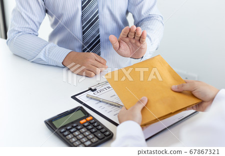 Businessmen make dollar payments while signing an investment agreement to be a partner in an illegal and successful manner, Bribery and corruption concept. Businessmen make dollar payments while signing an investment agreement to be a partner in an illegal and successful manner, Bribery and corruption concept. 67867321
