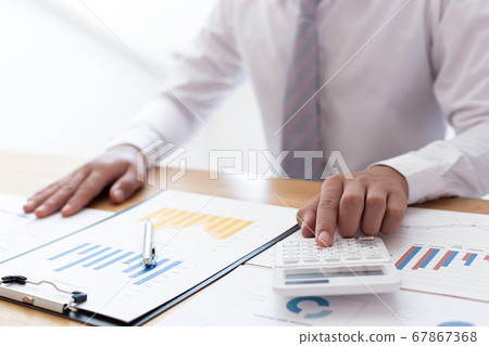 Businessmen use calculators to calculate the cost of real estate investments to prepare for offering to customers who want to share shares with the company, Business Financing Accounting Banking Conce 67867368