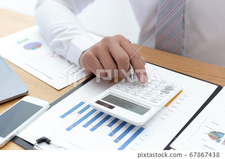 Businessmen use calculators to calculate the cost of real estate investments to prepare for offering to customers who want to share shares with the company, Business Financing Accounting Banking Conce 67867438