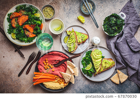 Vegan lunch table, top view. Flat-lay of sweet potato salad, avocado toast and hummus 67870030