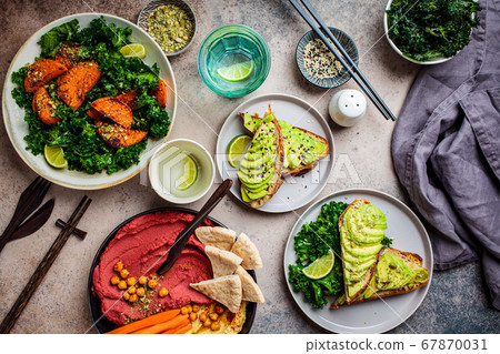 Vegan lunch table, top view. Flat-lay of sweet potato salad, avocado toast and hummus 67870031