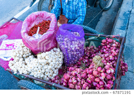 Asian street vendor sells seasonings, onions, Asian street vendor sells seasonings, onions, 67871191