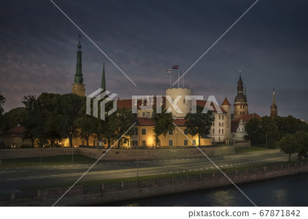 Riga, Latvia. View of the night city across the Daugava River. Riga Castle 67871842
