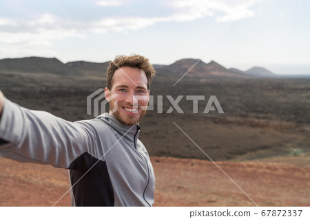 Travel tourist man taking selfie hiking in nature 67872337