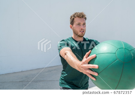 Workout fitness man training with medicine ball Workout fitness man training with medicine ball 67872357