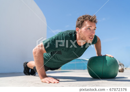 Push-up athlete strength training on medicine ball Push-up athlete strength training on medicine ball 67872376