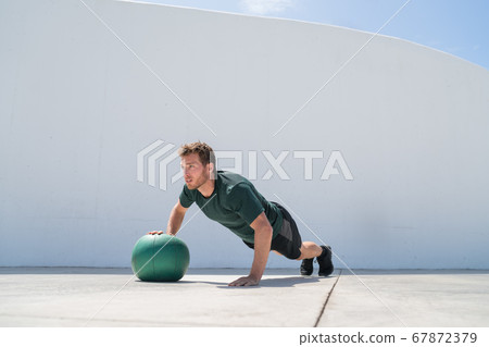 Fitness man strength training pushup medicine ball 67872379