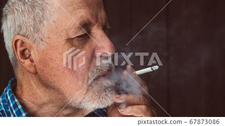 Senior man smoking cigarette outside, the cigarette addiction, unhealthy concept, bad habit 67873086