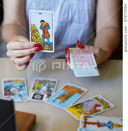 Defocused mystic ritual with tarot cards, and candles.  67873504