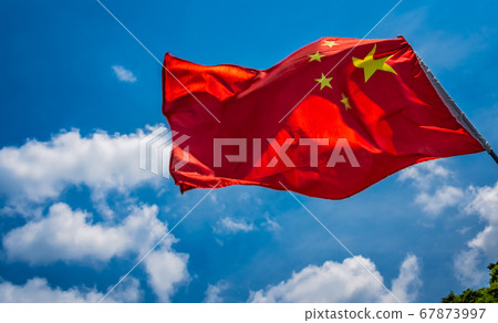 Red Chinese national flag with blue sky background Red Chinese national flag with blue sky background 67873997