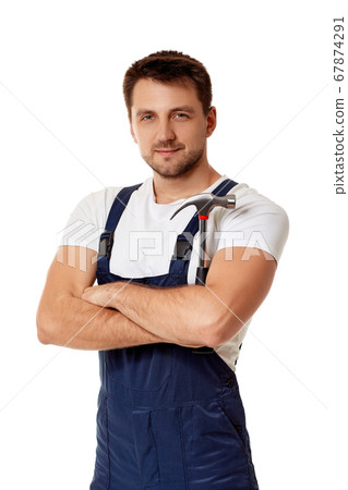 repairman in blue overalls holds hammer repairman in blue overalls holds hammer 67874291