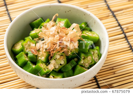 Summer vegetable okra sliced and ridiculous. Summer image in the background blinds. 67875079