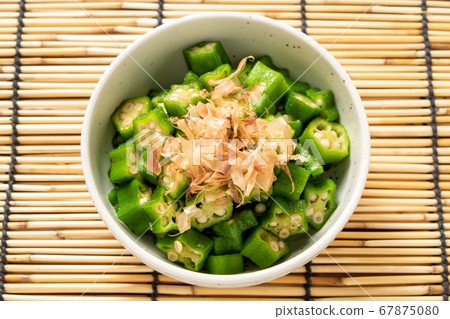 Summer vegetable okra sliced and ridiculous. Summer image in the background blinds. 67875080
