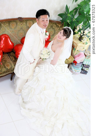 Bride and groom in a wedding dress and tuxedo photo wedding studio shot Bride and groom in a wedding dress and tuxedo photo wedding studio shot 67878325