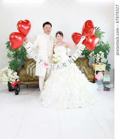 Bride and groom in a wedding dress and tuxedo photo wedding studio shot 67878327