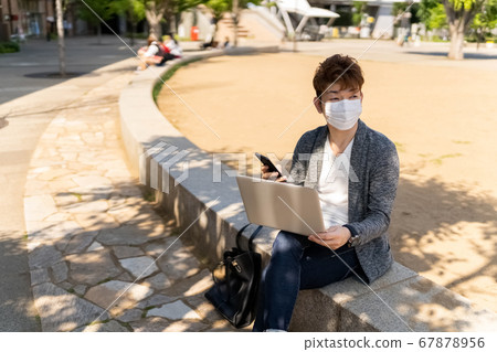 Business man freelance white mask outdoor smartphone operation 67878956
