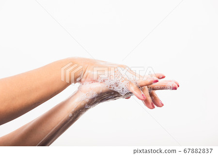 Woman washing hands by soap for cleanliness Woman washing hands by soap for cleanliness 67882837