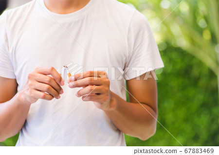 The man use hands breaking down cigarettes The man use hands breaking down cigarettes 67883469