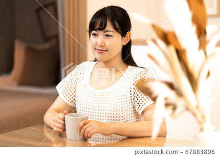 Young housewife having coffee time Young housewife having coffee time 67883808