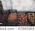 Onions and potatoes lined up in overseas greengrocers 67885069