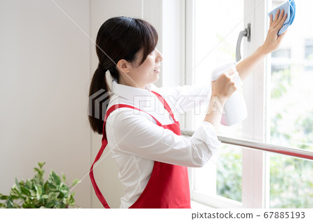 Housekeeping service Woman cleaning windows 67885193