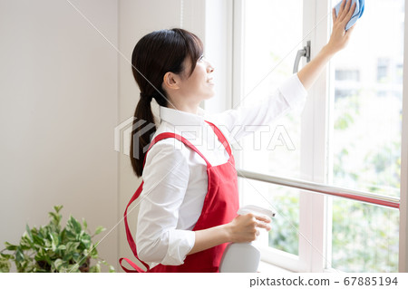 Housekeeping service Woman cleaning windows 67885194