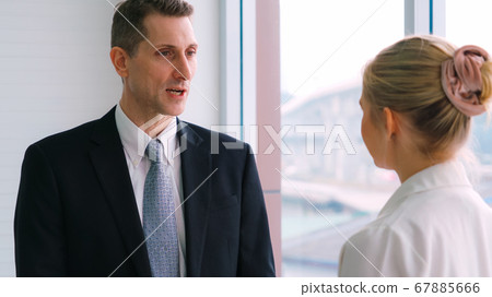 Two business people talk project strategy at office 67885666