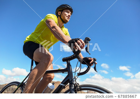 Biking tourist man cycling on road bike traveling Biking tourist man cycling on road bike traveling 67885667