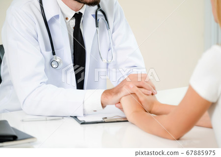 Male Doctor and Female Patient in Hospital Office 67885975
