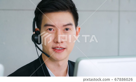 Business people wearing headset working in office Business people wearing headset working in office 67886026