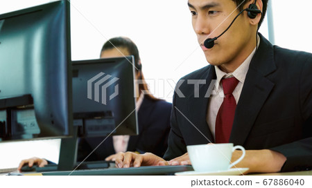 Business people wearing headset working in office Business people wearing headset working in office 67886040
