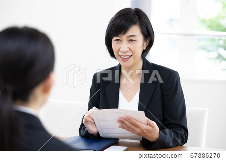 A manager woman taking an interview test 67886270
